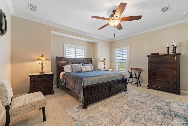 bedroom with ceiling fan, light carpet, and ornamental molding