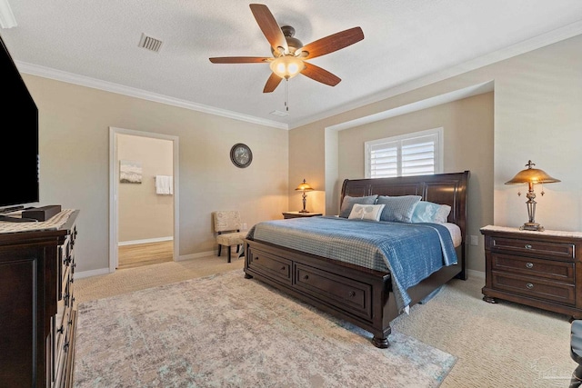 carpeted bedroom featuring a textured ceiling, ensuite bathroom, ceiling fan, and ornamental molding