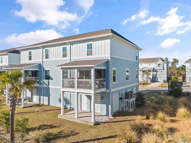 back of house featuring central AC and a yard