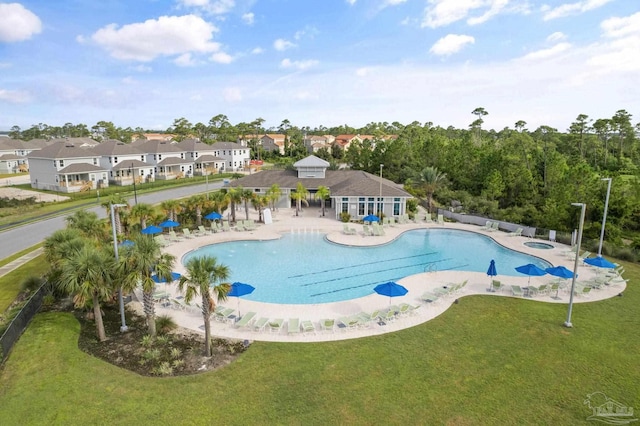 view of swimming pool with a lawn and a patio