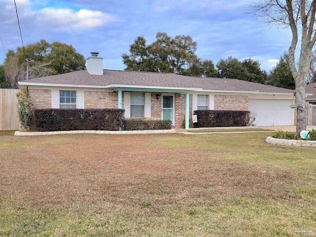 ranch-style house featuring a front yard and a garage