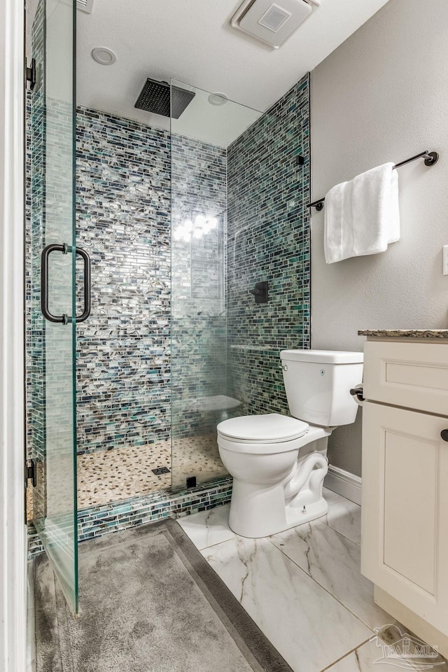 bathroom featuring toilet, an enclosed shower, and vanity