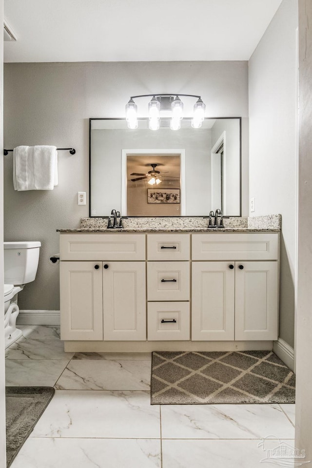 bathroom with toilet and vanity