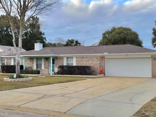 ranch-style home with a front lawn and a garage