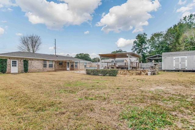 view of yard featuring a gazebo and a storage unit