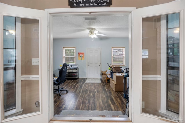 office with dark wood-type flooring, ceiling fan, and a textured ceiling