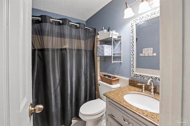 bathroom featuring a textured ceiling, vanity, toilet, and curtained shower