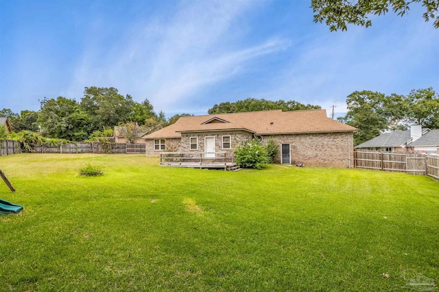 back of property featuring a yard and a deck