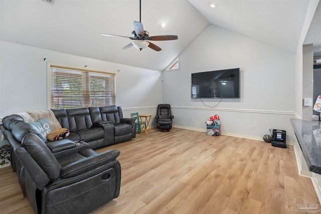 living room with high vaulted ceiling, ceiling fan, and light hardwood / wood-style floors