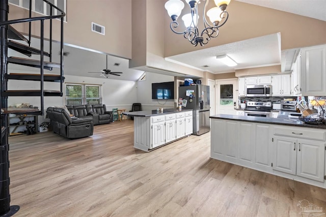 kitchen featuring ceiling fan with notable chandelier, stainless steel appliances, white cabinets, and light hardwood / wood-style floors