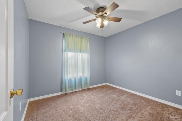 carpeted empty room featuring a textured ceiling and ceiling fan