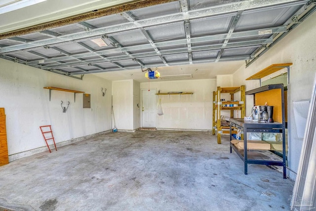 garage featuring electric panel and a garage door opener