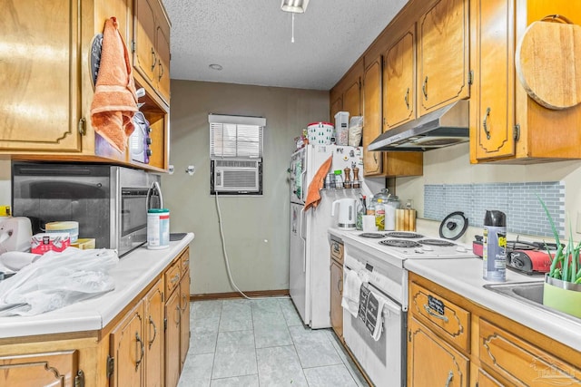 kitchen featuring light tile patterned flooring, cooling unit, white appliances, a textured ceiling, and backsplash