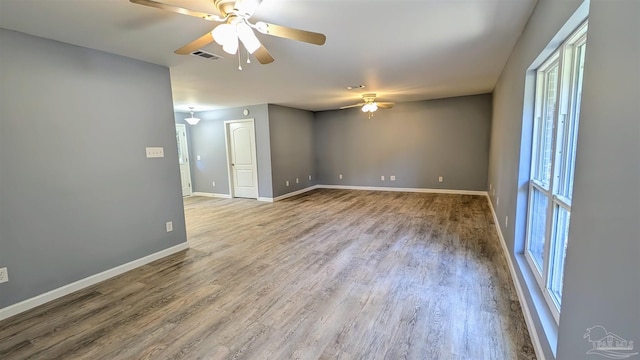6818 Roundup Ln, Milton, FL 32570 - empty room featuring ceiling fan, healthy amount of natural light, and wood finished floors