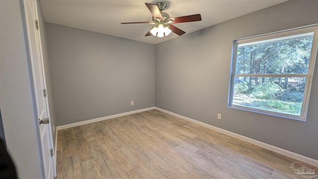 6818 Roundup Ln, Milton, FL 32570 - unfurnished room with plenty of natural light, light wood finished floors, baseboards, and a ceiling fan