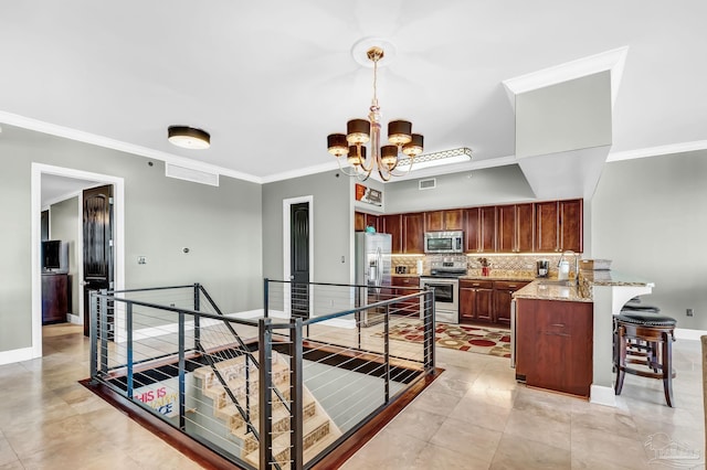 13928 River Rd Unit 904, Pensacola, FL 32507 - kitchen featuring tasteful backsplash, appliances with stainless steel finishes, a kitchen breakfast bar, a peninsula, and a notable chandelier