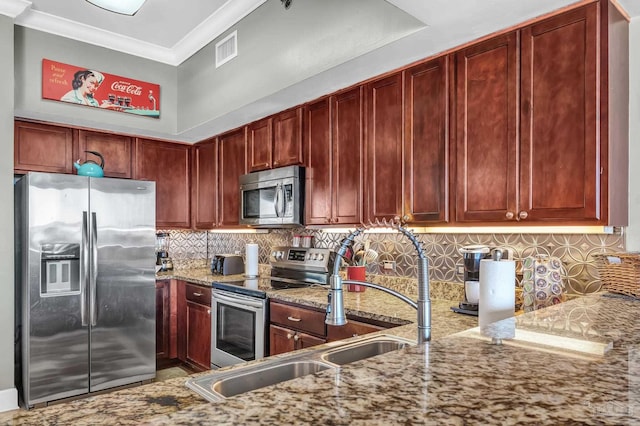 13928 River Rd Unit 904, Pensacola, FL 32507 - kitchen featuring visible vents, ornamental molding, light stone counters, stainless steel appliances, and reddish brown cabinets