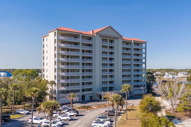 view of building exterior with uncovered parking