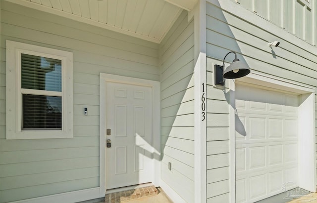 doorway to property with a garage