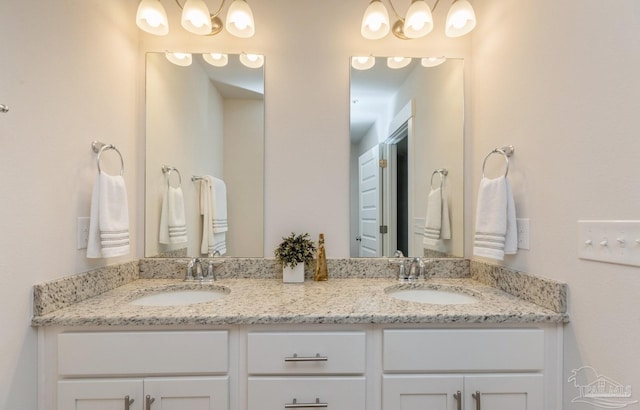 full bath with double vanity and a sink