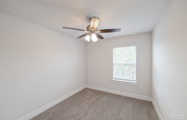 spare room featuring a ceiling fan, carpet flooring, and baseboards