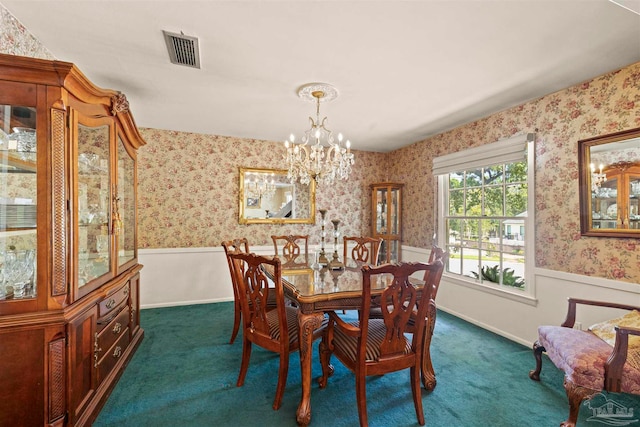 dining room featuring an inviting chandelier and dark colored carpet