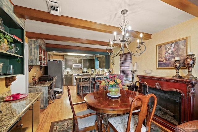 dining room featuring an inviting chandelier and light wood-type flooring