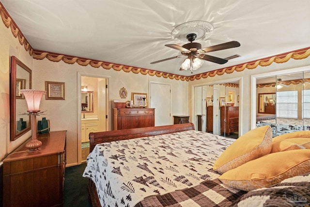 carpeted bedroom featuring ceiling fan, two closets, and connected bathroom