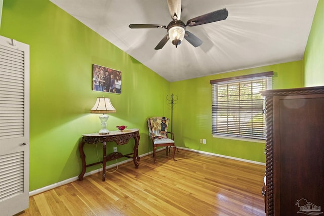 sitting room with ceiling fan, vaulted ceiling, and light hardwood / wood-style floors