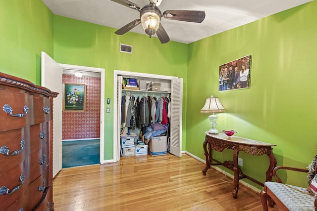 bedroom featuring ceiling fan, a closet, and light hardwood / wood-style floors