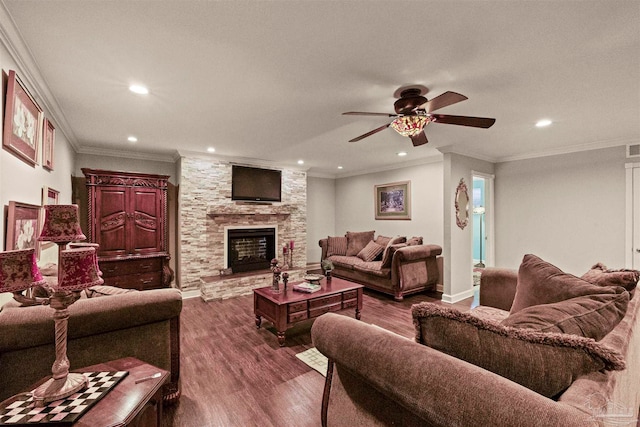 living room featuring crown molding, a stone fireplace, dark hardwood / wood-style floors, and ceiling fan