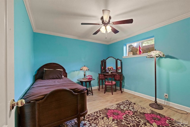 bedroom featuring ceiling fan, light hardwood / wood-style flooring, and crown molding