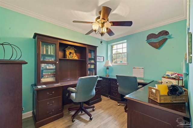 home office with light wood-type flooring, crown molding, and ceiling fan