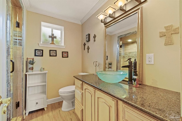 bathroom with vanity, walk in shower, wood-type flooring, crown molding, and toilet