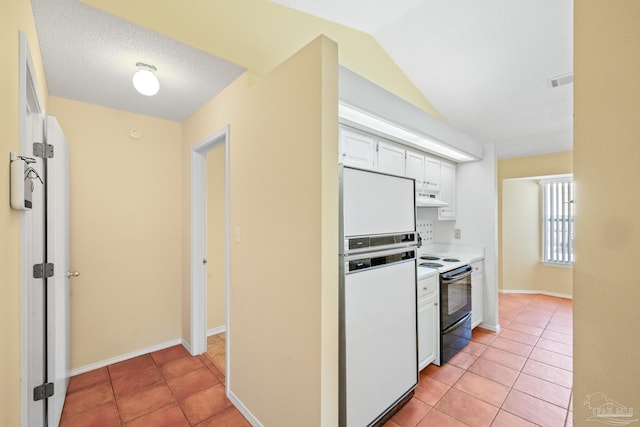 kitchen featuring white cabinetry, white fridge, black / electric stove, and light tile patterned floors