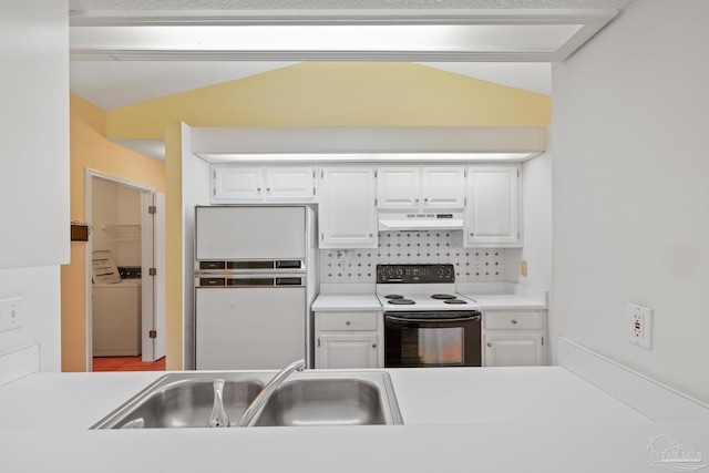 kitchen featuring electric stove, vaulted ceiling, white refrigerator, and white cabinets