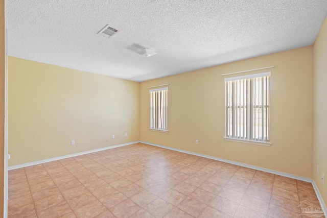 empty room featuring a textured ceiling