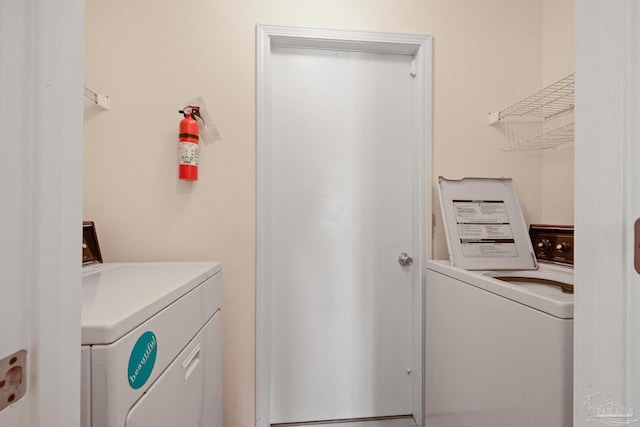 laundry area featuring washing machine and clothes dryer