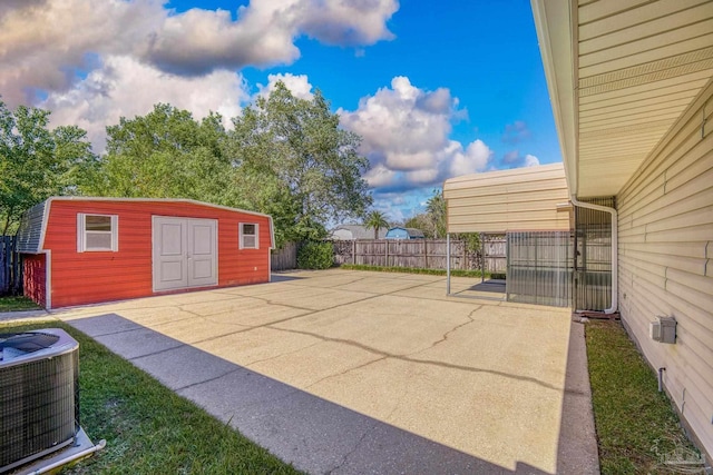 view of patio / terrace featuring central air condition unit and a shed