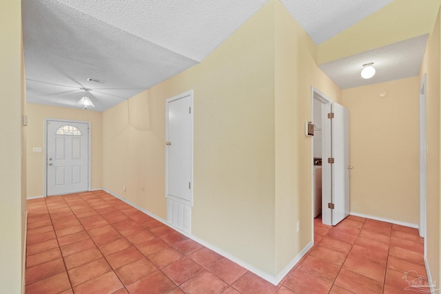 tiled foyer with a textured ceiling