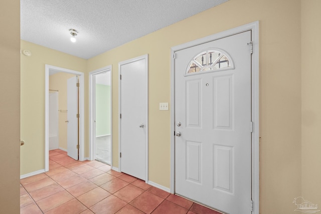 tiled entrance foyer featuring a textured ceiling