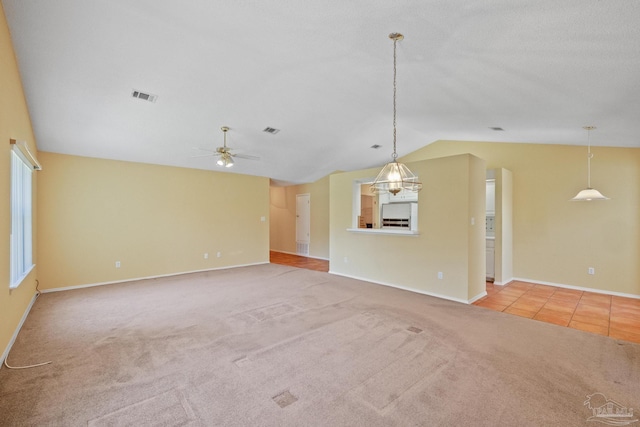 unfurnished living room with vaulted ceiling, light carpet, and ceiling fan