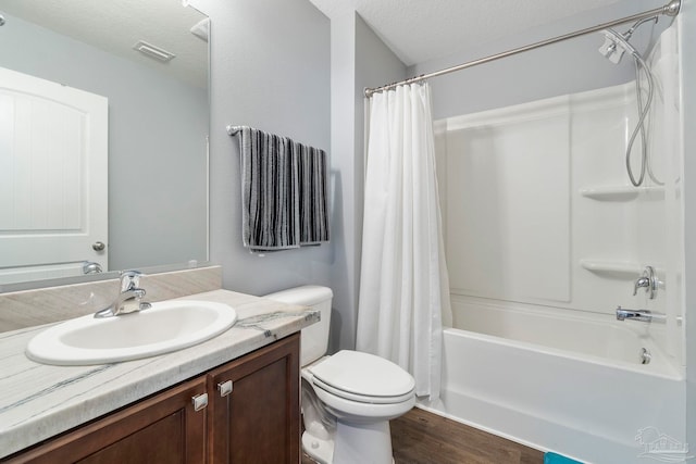 bathroom with visible vents, toilet, shower / tub combo with curtain, a textured ceiling, and vanity