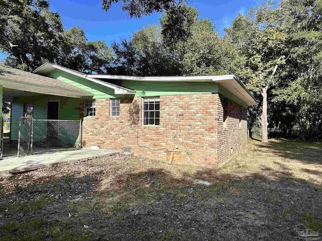 view of home's exterior featuring crawl space and brick siding