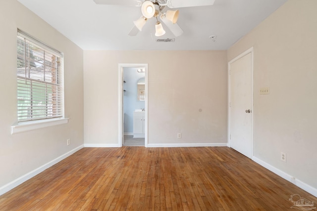 unfurnished bedroom featuring visible vents, a ceiling fan, baseboards, and hardwood / wood-style floors