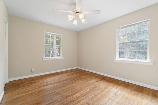 spare room with light wood-style flooring, baseboards, and ceiling fan