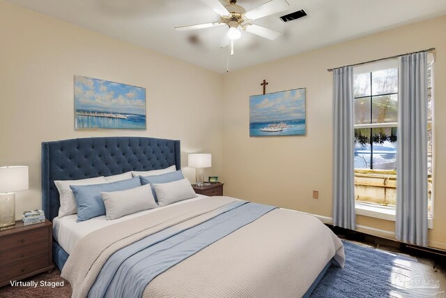 bedroom with hardwood / wood-style flooring and ceiling fan