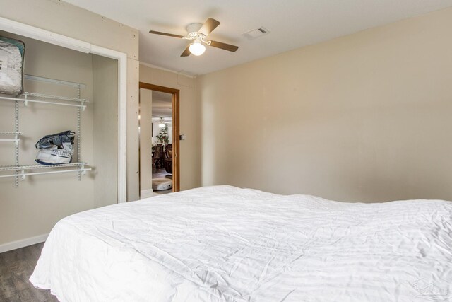 bedroom featuring a closet, ceiling fan, and dark hardwood / wood-style flooring