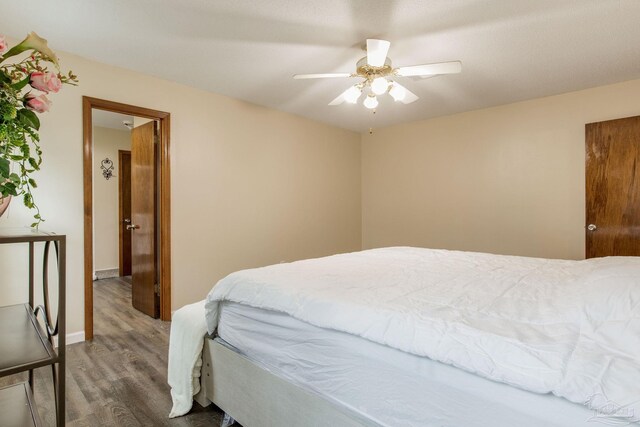 bedroom featuring hardwood / wood-style floors and ceiling fan