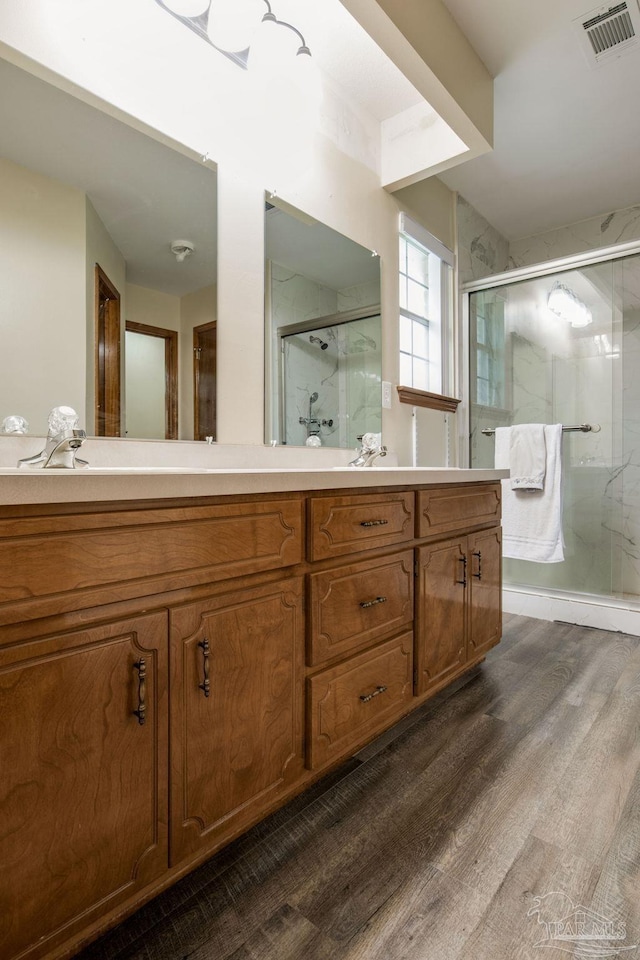 bathroom with vanity, hardwood / wood-style flooring, and walk in shower